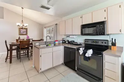 a kitchen with a sink and a stove top oven at Cozy Home Near Disney!!! in Kissimmee