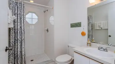 a bathroom with a toilet and a sink and a shower at Villas At Island Club Community, Pools, Jacuzzi And More! in Kissimmee