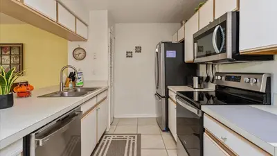 a kitchen with a sink and a stove at Villas At Island Club Community, Pools, Jacuzzi And More! in Kissimmee