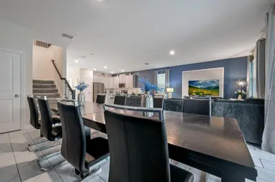 a dining room with a long table and chairs at Storey Lake Resort 1136 - Hosted by Top Villas in Kissimmee