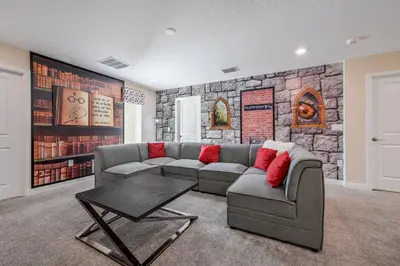 a living room with a couch and a stone wall at Storey Lake Resort 1136 - Hosted by Top Villas in Kissimmee