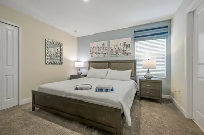 a bedroom with a bed and two lamps and a window at Storey Lake Resort 1136 - Hosted by Top Villas in Kissimmee