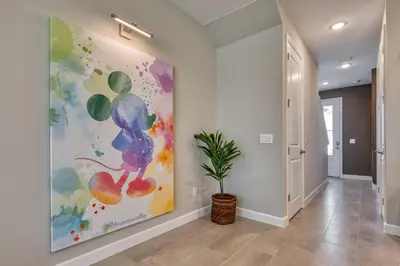 a hallway with a painting on the wall and a plant at Formosa Valley Resort 60 - Hosted by Top Villas in Orlando