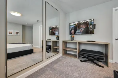 a bedroom with a bed and a desk with a mirror at Formosa Valley Resort 61 - Hosted by Top Villas in Orlando