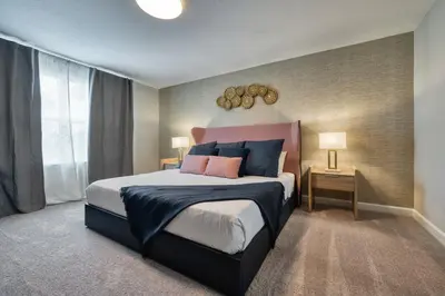 a bedroom with a large bed with blue and pink pillows at Formosa Valley Resort 62 - Hosted by Top Villas in Orlando
