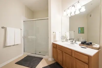 a bathroom with a shower and a sink and a mirror at Last Minute Disney Getaway Luxury Condo with Private Balcony. Book Now VC240 in Orlando