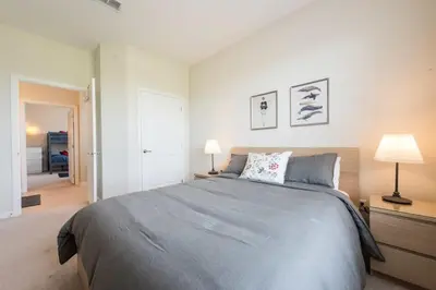 a bedroom with a large bed and two lamps at Last Minute Disney Getaway Luxury Condo with Private Balcony. Book Now VC240 in Orlando