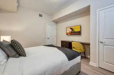 a bedroom with a bed and a desk with a yellow chair at Vista Cay 239 - Hosted by Top Villas in Orlando