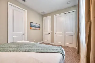 a bedroom with two white doors and a bed at Formosa Valley Resort 58 - Hosted by Top Villas in Orlando