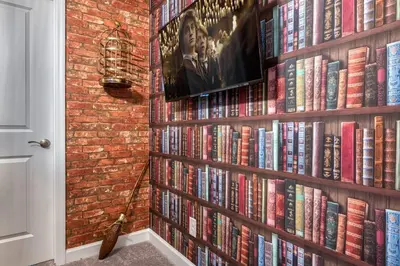 a book shelf filled with books next to a brick wall at Formosa Valley Resort 58 - Hosted by Top Villas in Orlando