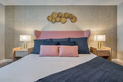a bedroom with a large bed with blue and pink pillows at Formosa Valley Resort 63 - Hosted by Top Villas in Orlando