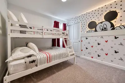 a childs bedroom with a bunk bed with mickey mouse wallpaper at Formosa Valley Resort 63 - Hosted by Top Villas in Orlando