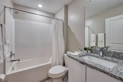 a white bathroom with a tub and a toilet and a sink at Formosa Valley Resort 64 - Hosted by Top Villas in Orlando