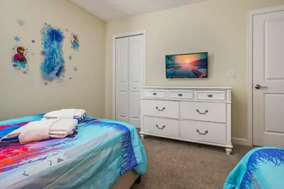 a bedroom with a bed and a dresser at Storey Lake Resort 1120 - Hosted by Top Villas in Kissimmee