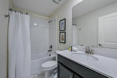 a white bathroom with a sink and a toilet at Storey Lake Resort 1120 - Hosted by Top Villas in Kissimmee