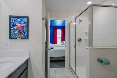 a bathroom with a shower and a sink and a bathroom with a bed at Storey Lake Resort 1120 - Hosted by Top Villas in Kissimmee