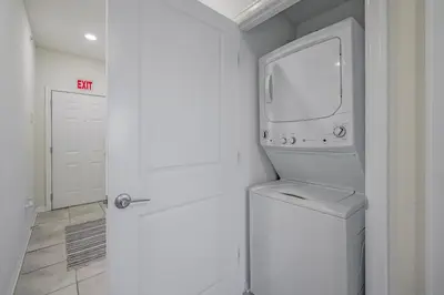 a white laundry room with a washer and dryer at Storey Lake Resort 1059 - Hosted by Top Villas in Kissimmee