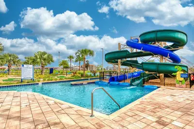 a water slide in a pool at a resort at Storey Lake Resort 1059 - Hosted by Top Villas in Kissimmee