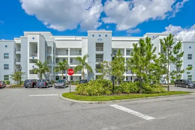 a parking lot in front of a building with a stop sign at Storey Lake Resort 1059 - Hosted by Top Villas in Kissimmee