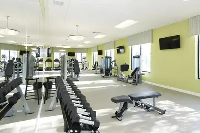 a fitness room with treadmills and tread machines at Beautiful 5bed home with Free Resort Access 4817 in Kissimmee