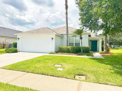 a house with a driveway and a garage at LB4701PL - 4 Beds villa - with pool and game room in Kissimmee
