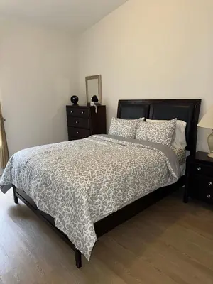 a bedroom with a bed with a black and white comforter at Magical Home with private pool and close to parks in Kissimmee