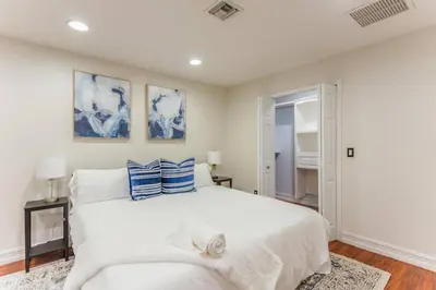 a bedroom with a large white bed with blue pillows at Private Oasis near Springs with King Bd and Pool Table in Orlando
