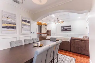 a dining room with a table and a couch at Private Oasis near Springs with King Bd and Pool Table in Orlando