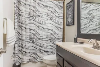 a bathroom with a sink and a toilet and a shower at Private Oasis near Springs with King Bd and Pool Table in Orlando