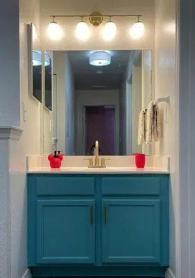 a bathroom with a blue sink and a mirror at 4 Bedroom 3 Bathroom Villas At SevenDwarfs 27-108 in Kissimmee