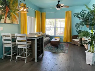 a living room with a table and chairs and a couch at 4 Bedroom 3 Bathroom Villas At SevenDwarfs 27-108 in Kissimmee