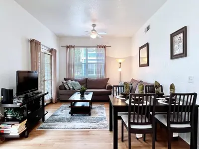a living room with a table and a couch at Cute and Cozy 4Bed Townhome Venetian Bay-2200SCD in Kissimmee