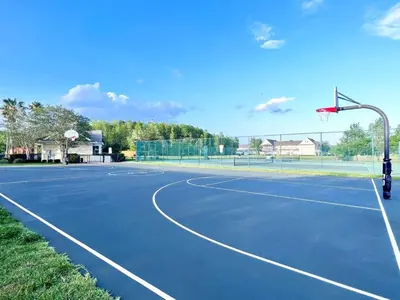a tennis court with a basketball hoop on it at Cute and Cozy 4Bed Townhome Venetian Bay-2200SCD in Kissimmee
