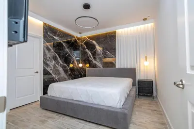 a bedroom with a bed and a stone wall at BRAND NEW 15Bed Home wprivate Pool 5824 in Orlando