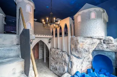 a castle themed room with a fake building and a chandelier at BRAND NEW 15Bed Home wprivate Pool 5824 in Orlando