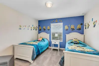 a bedroom with two beds and blue walls at Waterpark Disney wPoolLakeView Storey Lake in Kissimmee