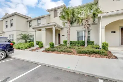 a car parked in front of a house with palm trees at Waterpark Disney wPoolLakeView Storey Lake in Kissimmee