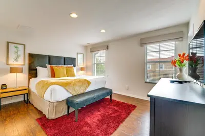 a bedroom with a bed and a red rug at 4 Mi to Disney World Townhome with Hot Tub and Lanai! in Kissimmee