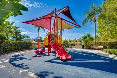 a playground with a red slide at 4 Mi to Disney World Townhome with Hot Tub and Lanai! in Kissimmee