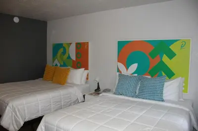two beds sitting next to each other in a room at Apartamento Perto Disney in Kissimmee