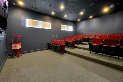 an empty theatre with red chairs in a room at Lakefront Villa in Terra Verde:Pool & Resort Amenities in Kissimmee