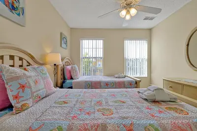 a bedroom with two beds and a ceiling fan at Lakefront Villa in Terra Verde:Pool & Resort Amenities in Kissimmee