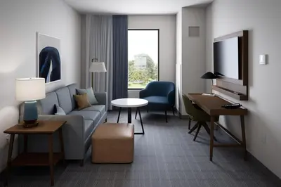a living room with a couch and a table at Staybridge Suites Clermont Southeast by IHG in Clermont