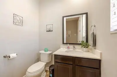 a bathroom with a toilet and a sink and a mirror at Corvette Getaway - 2 beds - jacuzzi - Forest view in Orlando