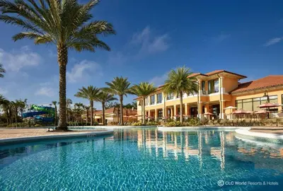 a swimming pool with palm trees and a building at Corvette Getaway - 2 beds - jacuzzi - Forest view in Orlando