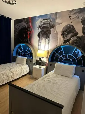 a room with two beds and a wall with a mural at Disney Area Retreat 6BR4BA with Private Pool Theater Game Room Bella Vida Resort BV4509 in Kissimmee