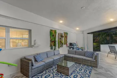 a living room with a couch and a table at Luxury Ranch Master King Bed with heated Salted Pool in Orlando