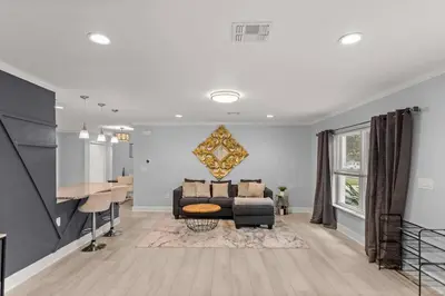 a living room with a couch and a table at Luxury Ranch Master King Bed with heated Salted Pool in Orlando