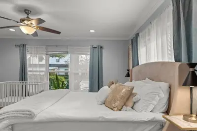 a bedroom with a bed with a teddy bear on it at Luxury Ranch Master King Bed with heated Salted Pool in Orlando