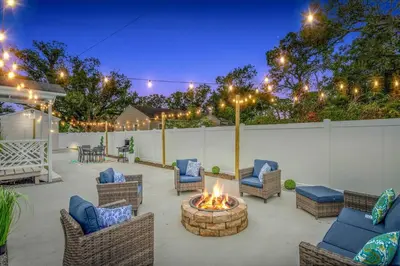 a patio with wicker chairs and a fire pit at King bd Charming 2-Storey Cottage w PrivateYard in Orlando
